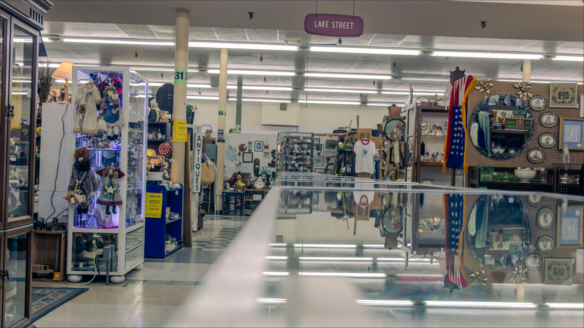 Inside Early Owego Antique Center showing vendor booths filled with antiques and collectibles